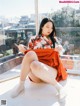 A woman sitting on a window sill with her legs crossed.